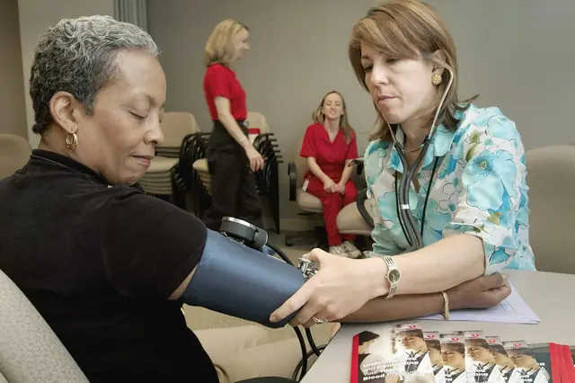 A health professional measuring a patient's blood pressure