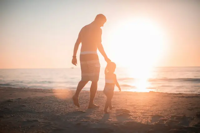 Two people walking together for support at sunset