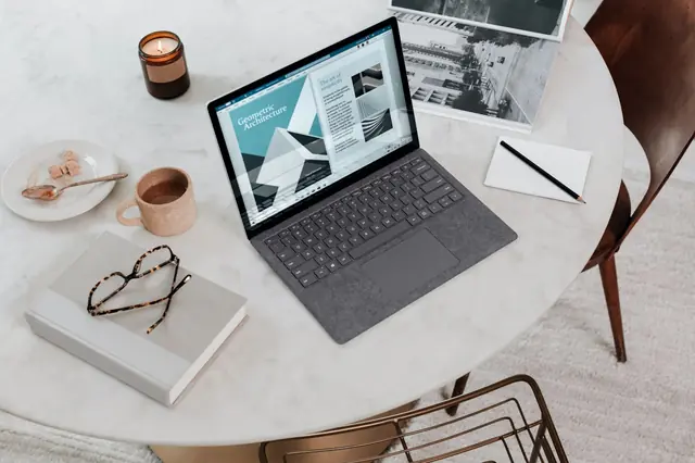 A tidy workspace with a laptop and documents